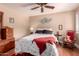 Cozy bedroom featuring neutral walls, a ceiling fan, and traditional furnishings at 8302 S Jentilly Ln, Tempe, AZ 85284