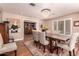 Formal dining room with elegant chandelier, hardwood floors, and stylish furnishings at 8302 S Jentilly Ln, Tempe, AZ 85284