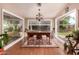 Bright dining room features hardwood floors, large windows, and a chandelier at 8302 S Jentilly Ln, Tempe, AZ 85284