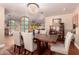 Dining room with hardwood floors, chandelier, and a view into another room at 8302 S Jentilly Ln, Tempe, AZ 85284