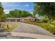Charming home featuring a large, gray brick driveway and lush landscaping with colorful flowers at 8302 S Jentilly Ln, Tempe, AZ 85284