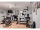 Finished basement gym with wood flooring, workout equipment, and drop ceiling at 8302 S Jentilly Ln, Tempe, AZ 85284