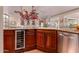 View of kitchen island with stainless steel appliances and a wine cooler at 8302 S Jentilly Ln, Tempe, AZ 85284