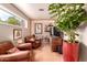 Inviting living room features hardwood floors, comfortable seating, and a decorative plant for a cozy atmosphere at 8302 S Jentilly Ln, Tempe, AZ 85284