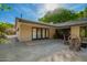 Outdoor patio with stone flooring, cozy seating, and a view of mature greenery at 8302 S Jentilly Ln, Tempe, AZ 85284