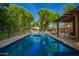 Backyard swimming pool featuring lush greenery and a relaxing atmosphere at 8302 S Jentilly Ln, Tempe, AZ 85284