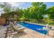 Inviting pool area with lounge chairs, umbrella and cool water at 8302 S Jentilly Ln, Tempe, AZ 85284