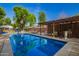 Backyard pool with a wooden deck and a covered bar area for outdoor entertaining at 8302 S Jentilly Ln, Tempe, AZ 85284