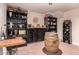 Well-stocked wine cellar with wooden shelves and brick flooring at 8302 S Jentilly Ln, Tempe, AZ 85284