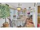 Bright dining area featuring a glass table, chandelier and view to the kitchen at 919 E Villa Maria Dr, Phoenix, AZ 85022