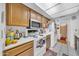 Bright kitchen shows white appliances, including a microwave, and wood cabinets at 919 E Villa Maria Dr, Phoenix, AZ 85022