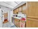 Bright kitchen with stainless steel appliances, white tile floor, and a view to an adjacent bathroom at 919 E Villa Maria Dr, Phoenix, AZ 85022