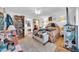 Bright main bedroom shows a ceiling fan, a full bookcase, and an ensuite bath at 919 E Villa Maria Dr, Phoenix, AZ 85022