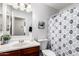 Bathroom with a sink, toilet, and a shower with a curtain at 937 N Marble St, Gilbert, AZ 85234