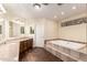 This bathroom includes a bathtub, a vanity with double sinks, and recessed lighting at 937 N Marble St, Gilbert, AZ 85234