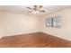 This bedroom offers lots of natural light with wood flooring and a ceiling fan at 937 N Marble St, Gilbert, AZ 85234