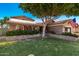Charming single-story home with a landscaped front yard, solar panels, and an American flag at 937 N Marble St, Gilbert, AZ 85234
