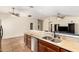 Open-concept layout overlooking the kitchen with tile flooring, granite counters, and stainless-steel appliances at 937 N Marble St, Gilbert, AZ 85234