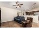 Cozy living room featuring a blue sofa, recliner, and tile flooring at 937 N Marble St, Gilbert, AZ 85234