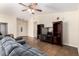 Comfortable living room with a large television, ceiling fan, and tile flooring at 937 N Marble St, Gilbert, AZ 85234
