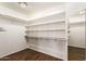 This walk-in closet has built in shelving and hardwood floors at 937 N Marble St, Gilbert, AZ 85234