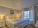 Bright bedroom with a queen-sized bed, decorative pillows, and a window providing natural light at 9450 E Becker Ln # 2099, Scottsdale, AZ 85260