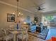 Inviting dining area featuring a chandelier, dining table set for four, and access to a private outdoor patio at 9450 E Becker Ln # 2099, Scottsdale, AZ 85260