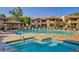 Community pool and spa area with lounge chairs, tables, and umbrellas for relaxation and enjoyment at 9450 E Becker Ln # 2099, Scottsdale, AZ 85260