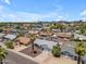 Aerial view of a residential neighborhood featuring homes, palm trees, and city skyline at 1020 E Concorda Dr, Tempe, AZ 85282