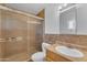 Bathroom featuring tile counter, frosted glass shower, toilet, and neutral color palette at 1020 E Concorda Dr, Tempe, AZ 85282
