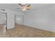 Bedroom with tile flooring, ceiling fan, closet with mirror doors, and neutral paint at 1020 E Concorda Dr, Tempe, AZ 85282