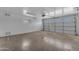 Empty garage featuring cement floors and painted white brick walls at 1020 E Concorda Dr, Tempe, AZ 85282
