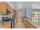 Kitchen features granite countertops, stainless steel appliances, and updated lighting at 1020 E Concorda Dr, Tempe, AZ 85282