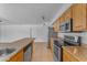 Updated kitchen with stainless steel appliances, stone countertops, and light wood cabinets and tile floors at 1020 E Concorda Dr, Tempe, AZ 85282
