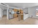 A well-lit kitchen with an island, wooden cabinets, and stainless steel appliances at 1020 E Concorda Dr, Tempe, AZ 85282
