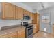 Kitchen view highlighting updated stainless steel appliances, granite countertops, and tile floor at 1020 E Concorda Dr, Tempe, AZ 85282