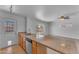 Bright kitchen with stainless steel appliances, granite counters, and breakfast bar overlooking living area at 1020 E Concorda Dr, Tempe, AZ 85282