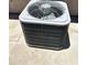 A gray air conditioner unit is sitting on a concrete pad outside a home at 1040 W Juniper Ave, Gilbert, AZ 85233
