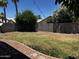 Lush backyard featuring mature trees, green grass, and a charming stone-lined walkway at 1040 W Juniper Ave, Gilbert, AZ 85233