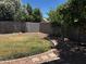 Private backyard oasis with mature trees, desert landscaping, and block fencing at 1040 W Juniper Ave, Gilbert, AZ 85233