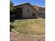 Well-maintained backyard with green grass, landscaping, and a covered patio at 1040 W Juniper Ave, Gilbert, AZ 85233