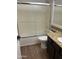 Bathroom with glass enclosed shower-tub combination, wood look floors, and granite counters at 1040 W Juniper Ave, Gilbert, AZ 85233