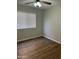 Bedroom with wood-look floors, ceiling fan and a window for natural light at 1040 W Juniper Ave, Gilbert, AZ 85233