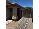Pathway leading to the front door, featuring desert-style landscaping and a security gate at 1040 W Juniper Ave, Gilbert, AZ 85233