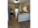 Open-concept kitchen with stainless steel appliances, wood cabinets, granite countertops, and bar top at 1040 W Juniper Ave, Gilbert, AZ 85233