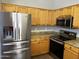 An eat-in kitchen featuring stainless steel appliances, wood cabinets, and granite countertops at 1040 W Juniper Ave, Gilbert, AZ 85233