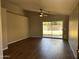 Bright living room features wood floors, a ceiling fan, and sliding glass doors to the backyard at 1040 W Juniper Ave, Gilbert, AZ 85233