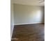 Large living room with wood-look floors, baseboards, and electrical outlets at 1040 W Juniper Ave, Gilbert, AZ 85233