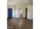 Spacious living room with hardwood floors, neutral walls, and an arched entryway at 1040 W Juniper Ave, Gilbert, AZ 85233
