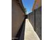 Side yard access with a concrete walkway and secure block wall, enhancing privacy at 1040 W Juniper Ave, Gilbert, AZ 85233